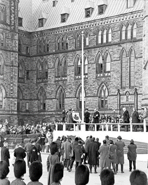 The red-and-white, Maple Leaf flag is raised for the first time on Parliament Hill